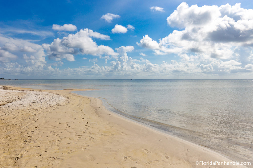 secluded beach in the florida panhandle with golden sands and clear water