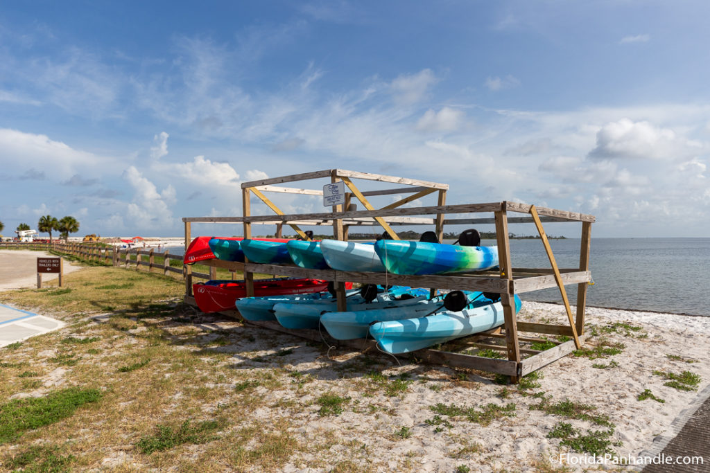 a wooden structure holding kayaks 