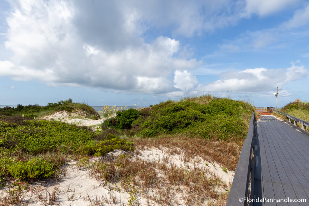 a wooden walkway to the beach