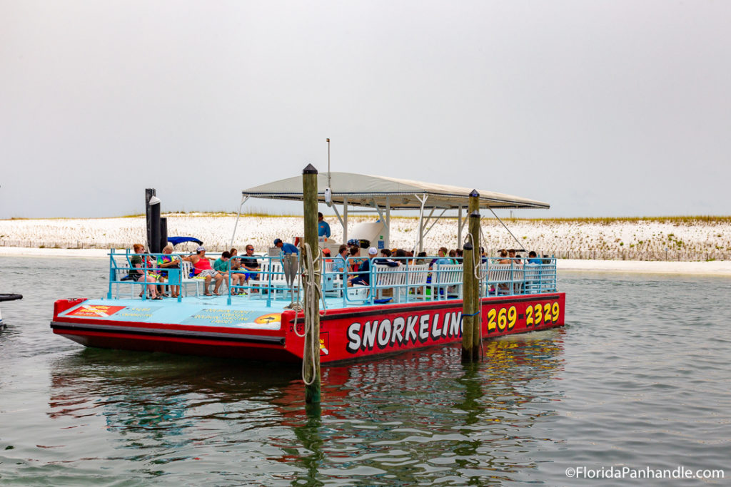 a group of people on a boat setting out into the water