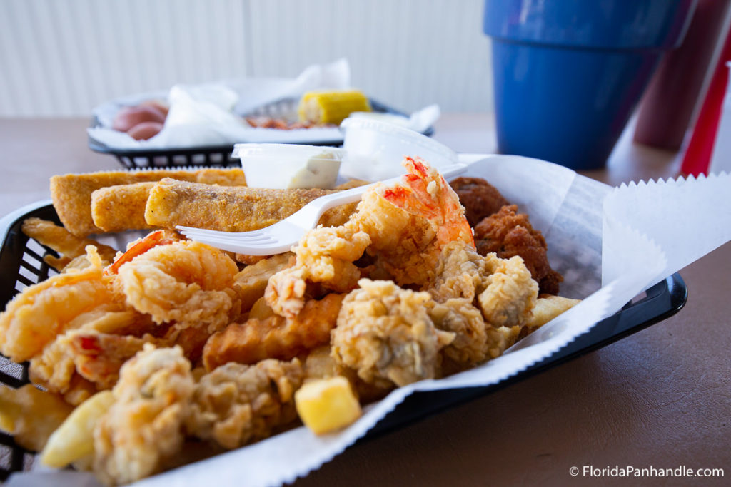 a basket of fried shrimp and calamari  at Dewey Destin's Harborside