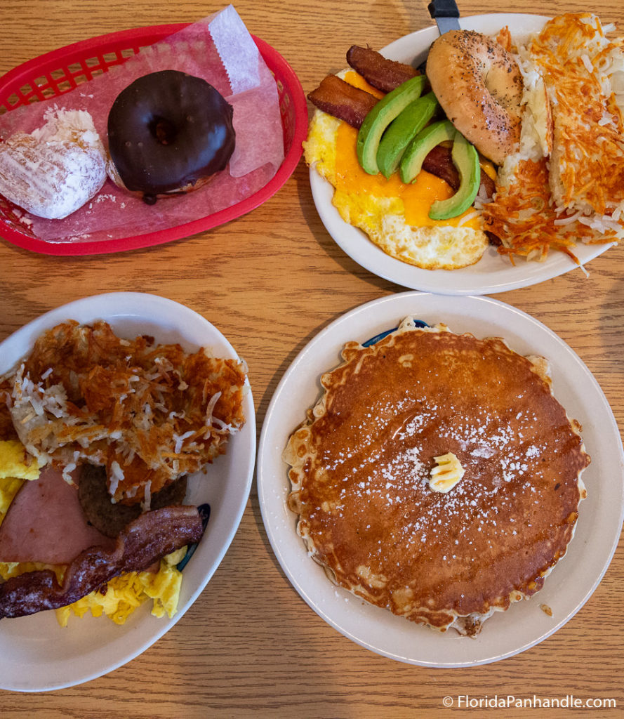 four plates with breakfast food