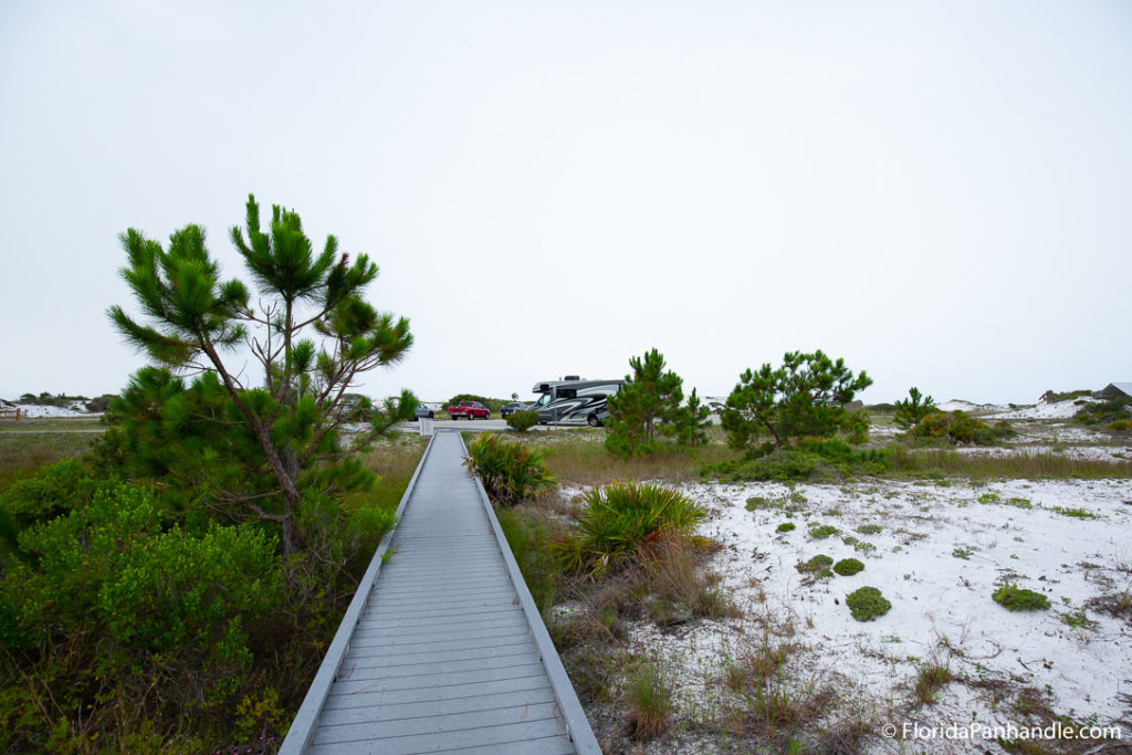 a wooden walkway leading from the beach to the parking lot at Grayton Beach State Park