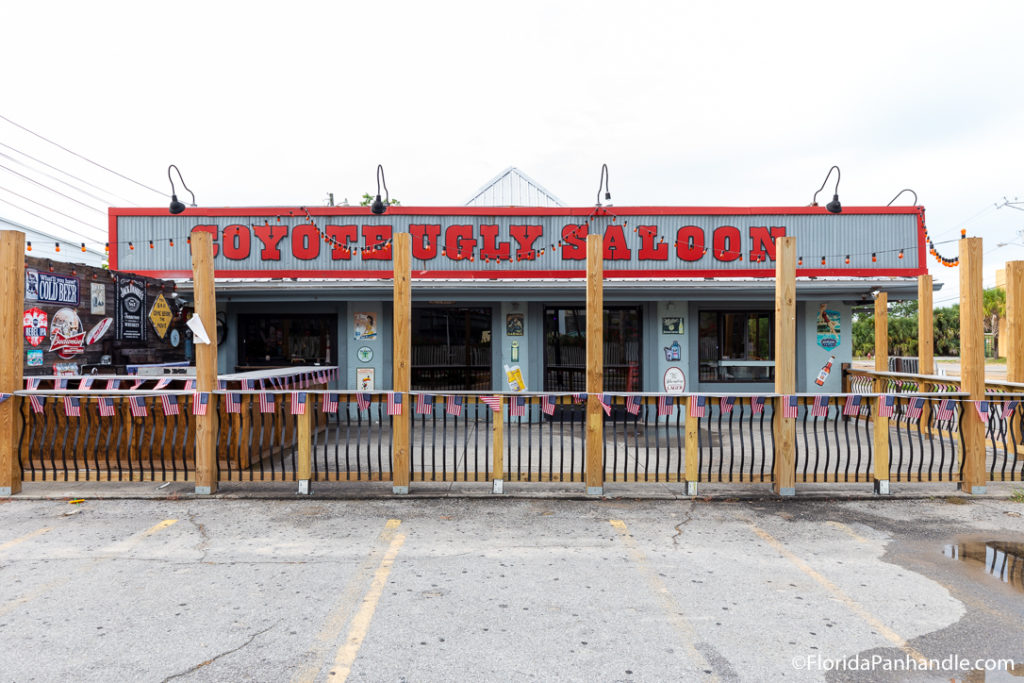 the outside of a grey building with big red letters on it