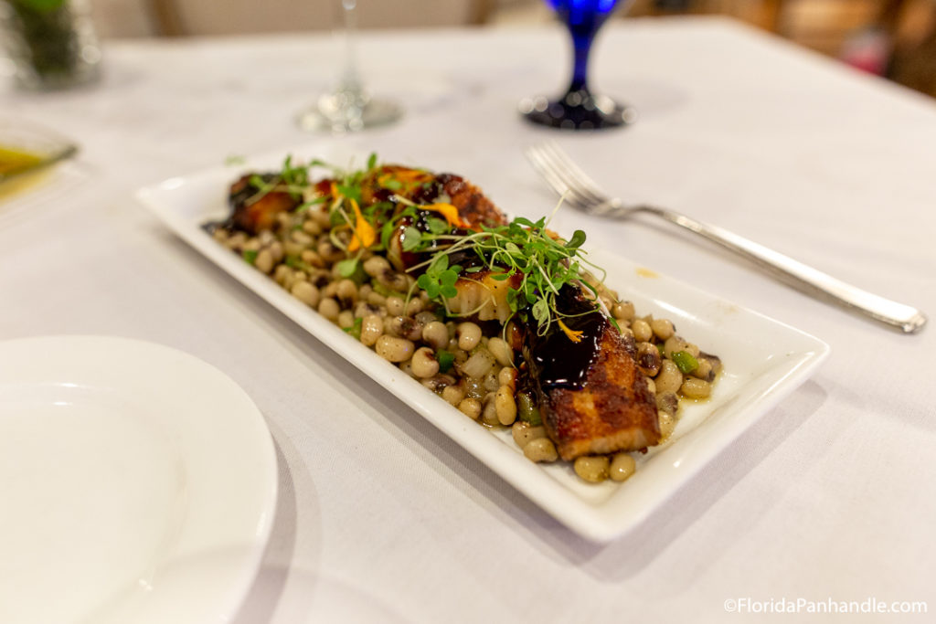 plate of seared salmon on a bed of corn and pinto beans at Beach Walk Cafe