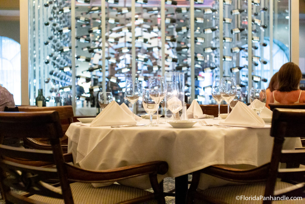 interior of a fancy dining establishment with white tablecloth in destin