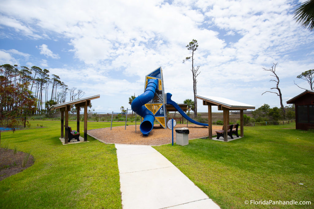 a children's park with a big blue slide during the day
