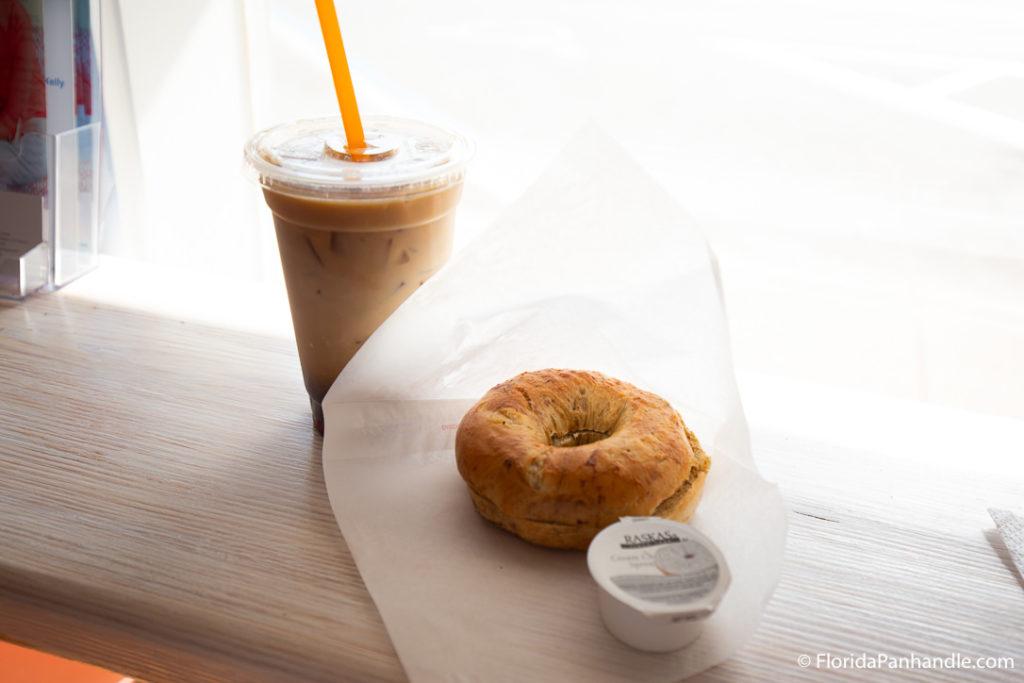 an iced coffee, bagel and cream cheese