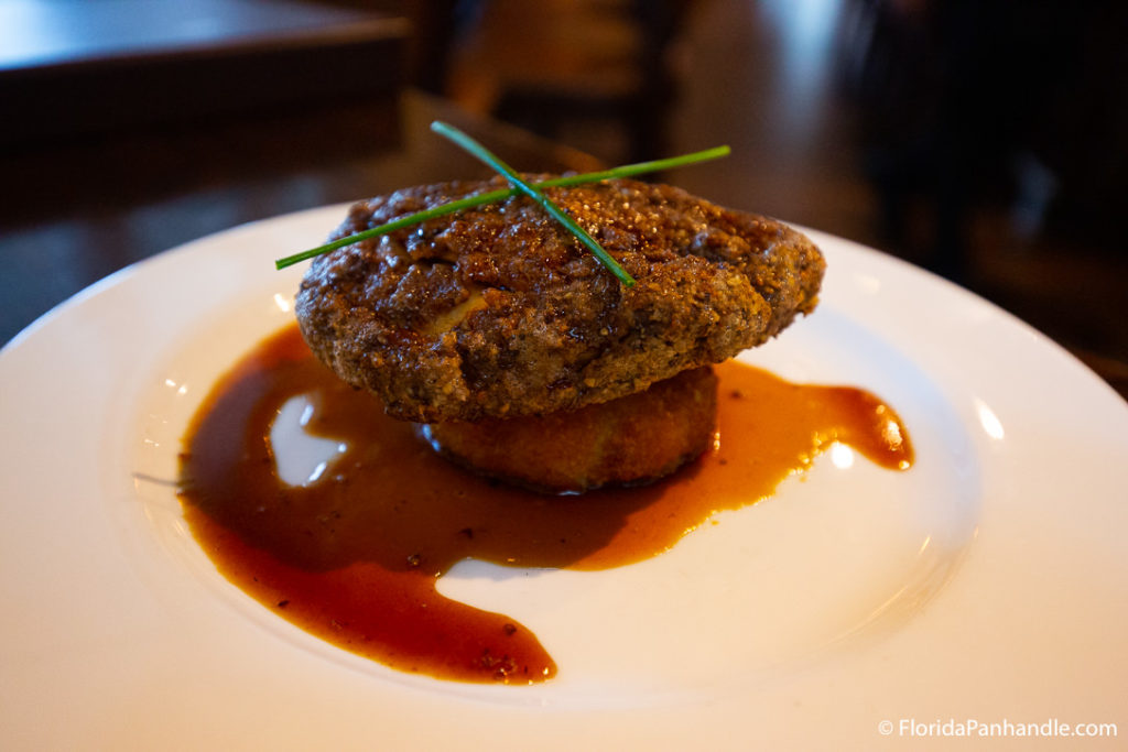 a steak on top of a mini potato cake