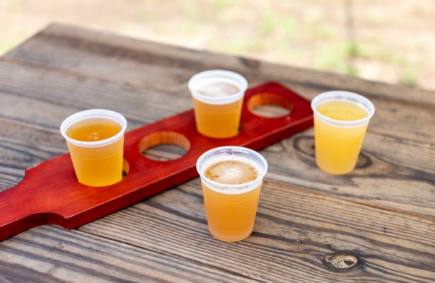 an array of beer by flight on top of wooden table