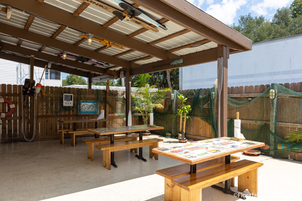 outside seating with benches and a sun cover at Scooter's Fish House in Pensacola Beach Florida