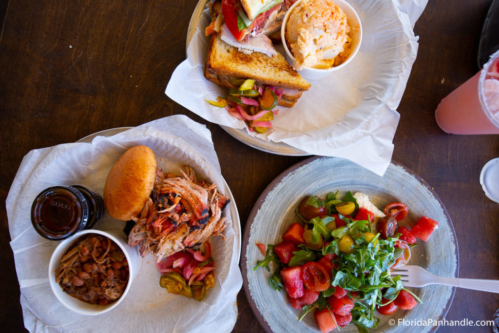 plate of BBQ burger with a side of smoked beans with a salad on the side at Water Pig BBQ