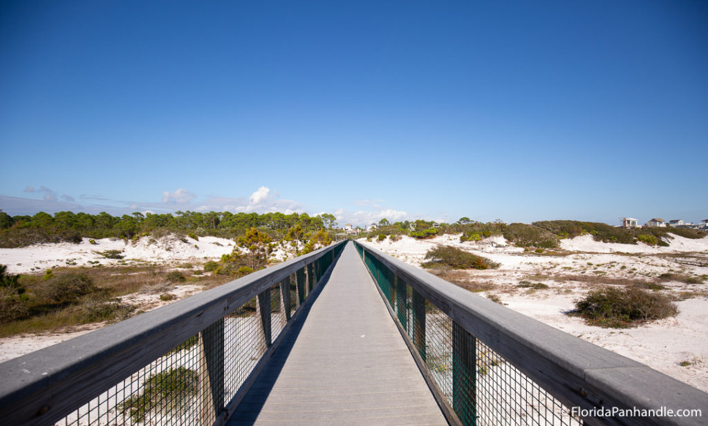 a wooden walkway to the beach 