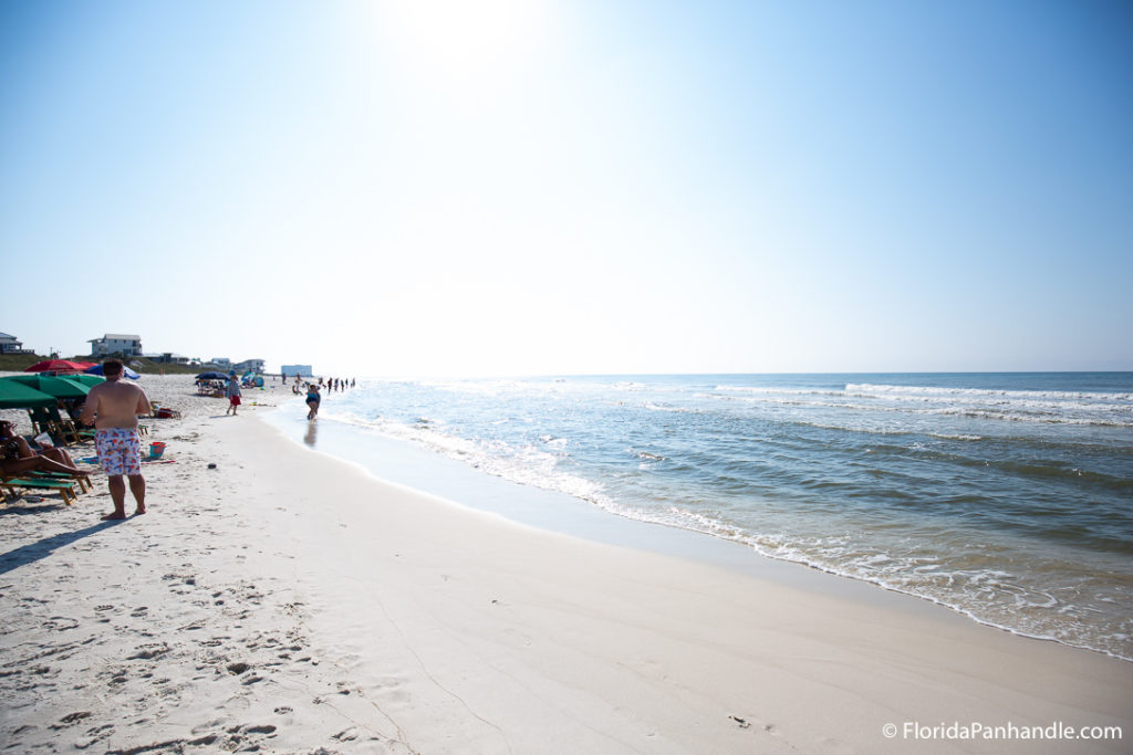 people at the beach on a bright sunny day