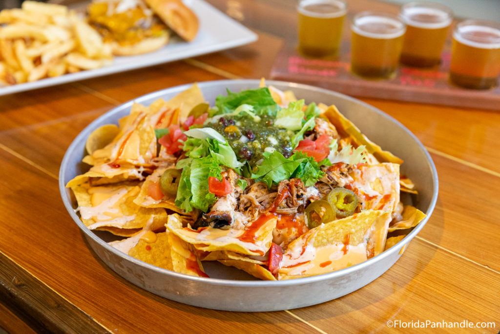 a platter of nachos with jalapeños 