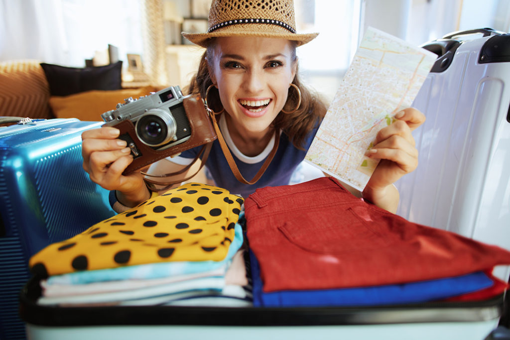 a woman holding a map and a camera