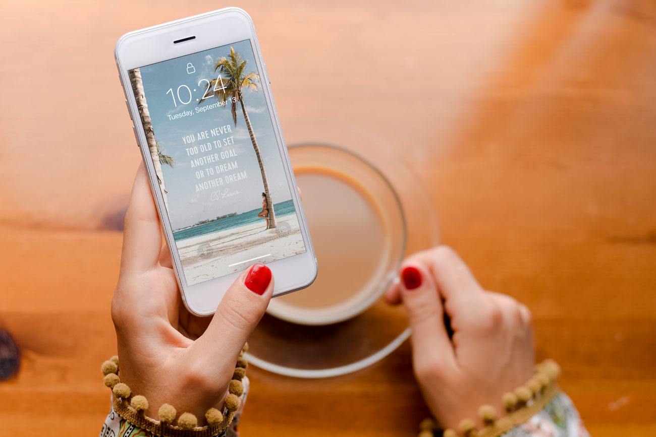 person holding phone with inspirational wallpaper