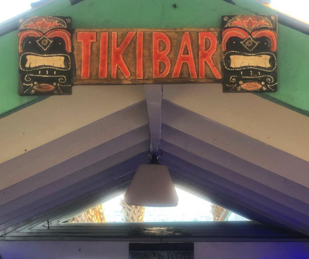 a giant tiki bar sign with red letters
