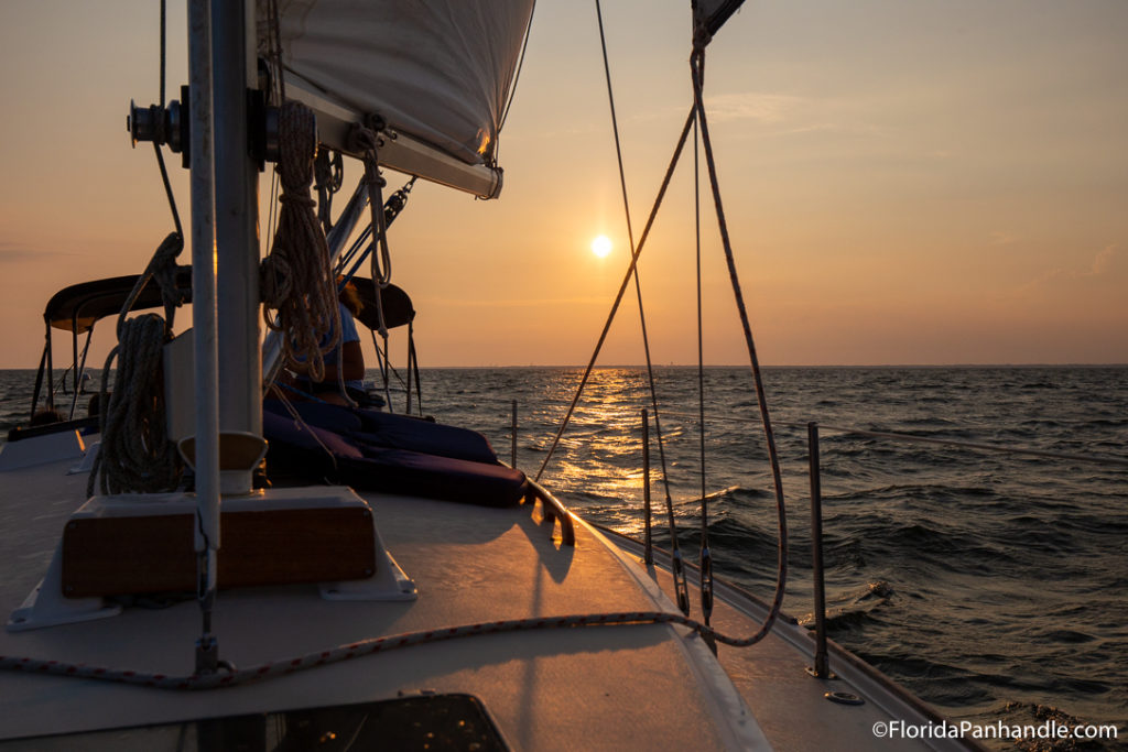 sunset view from sailboat in pensacola at jolly sailing & dolphin cruises