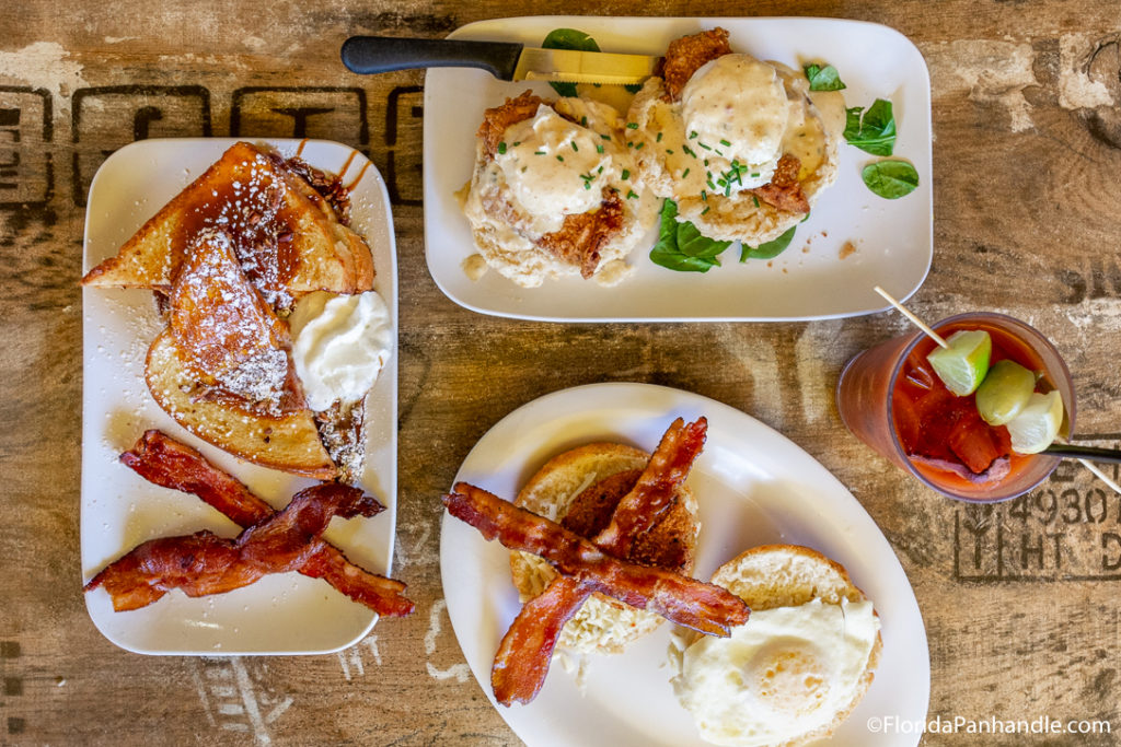 above view of brunch plates on white plates next to bloody mary