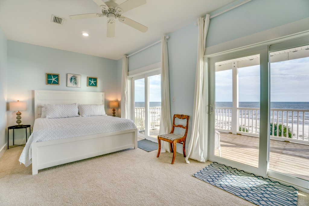 bedroom with doors leading to deck that faces the beach in cape san blas florida