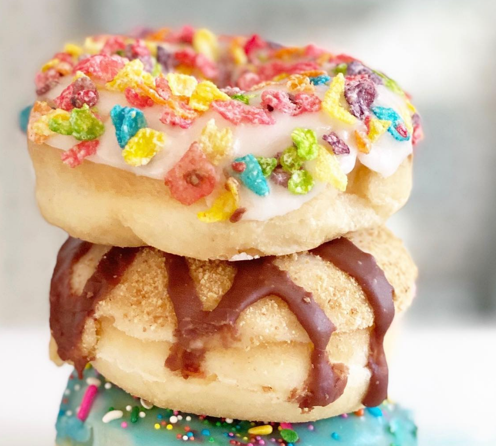 iced donuts stacked on top of each other, sweet, treats, dessert