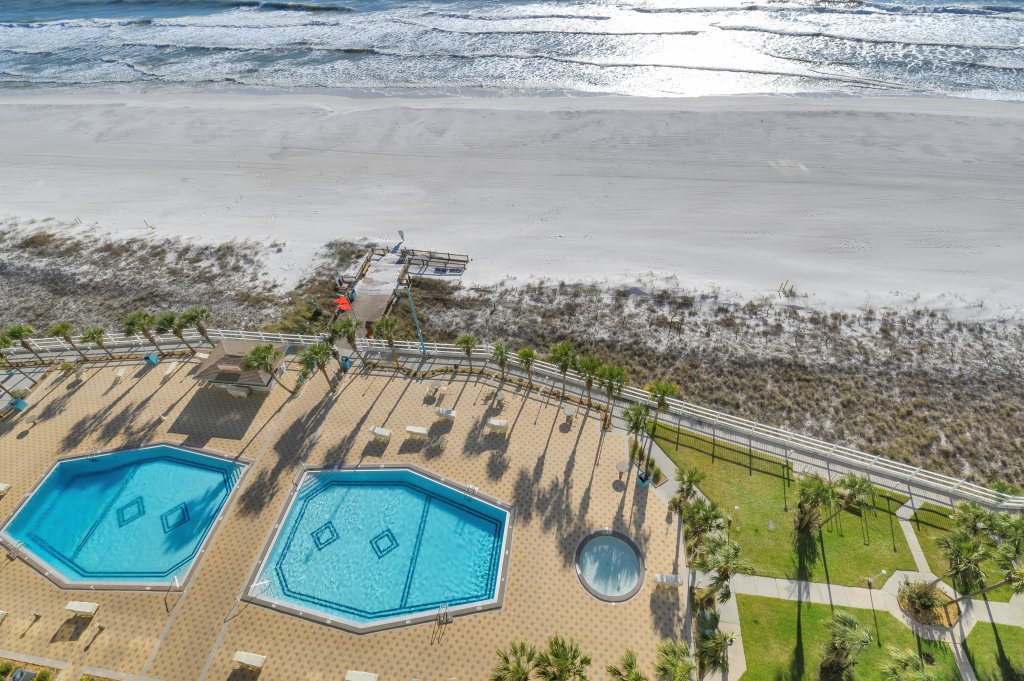 a birds eye view of two pools facing each other right off the beach at Summit Beach Resort in Panama City Beach Florida