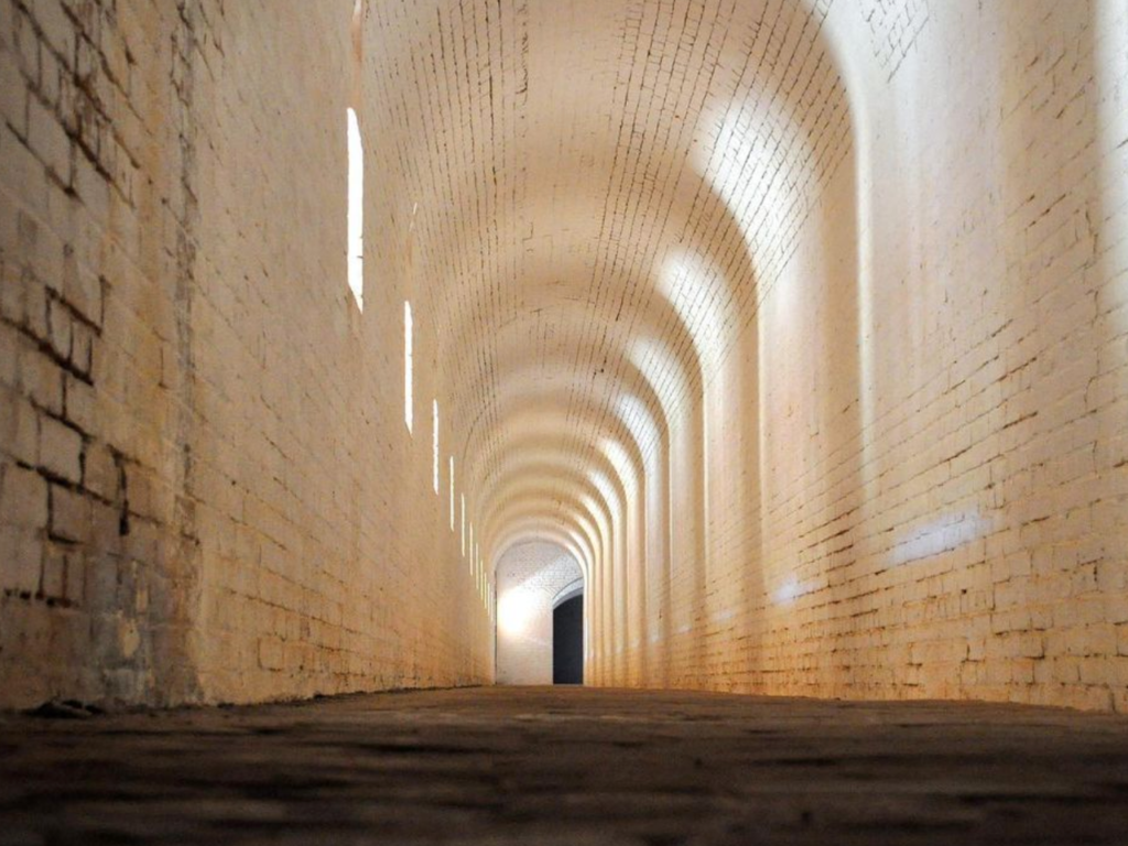 a long hallway with a rounded arch