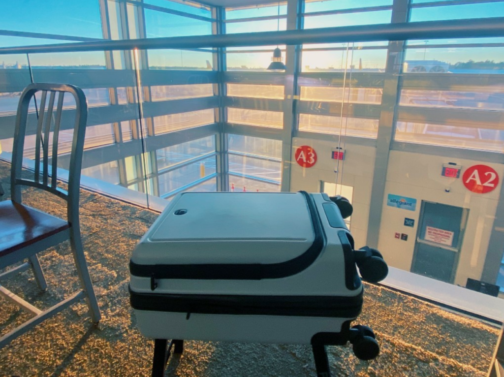 luggage at fort-walton destin airport with sunset shining upon the windows in the background