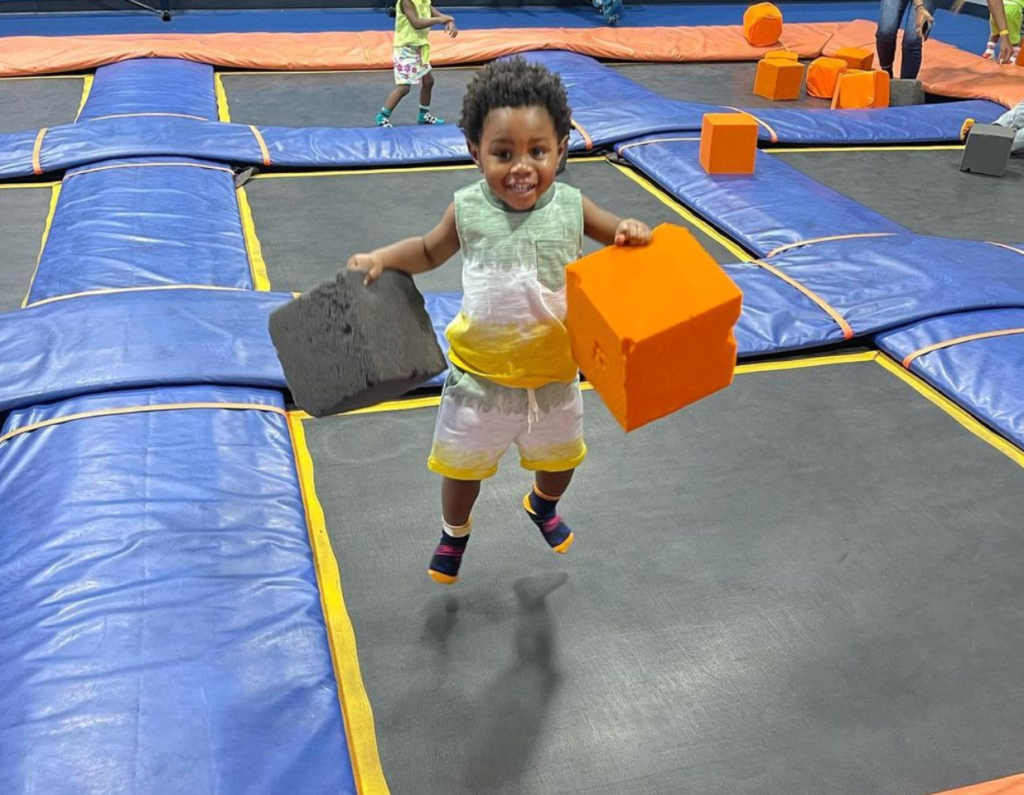 sky zone trampoline park, family-friendly attraction, pensacola, toddler jumping on trampoline